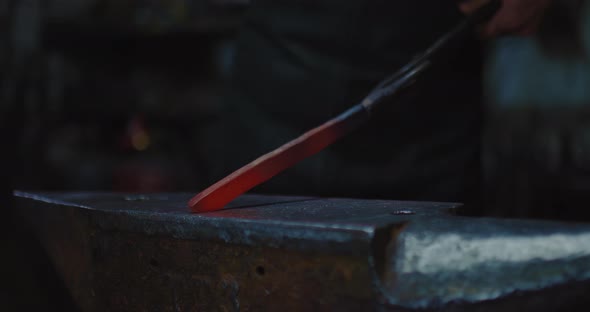 Professional Blacksmith Shaping Future Knife By Hammer and Anvil in Forge Closeup View  Prores