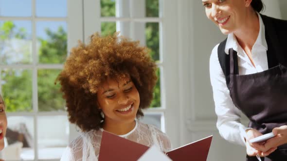 Friends placing order to waitress