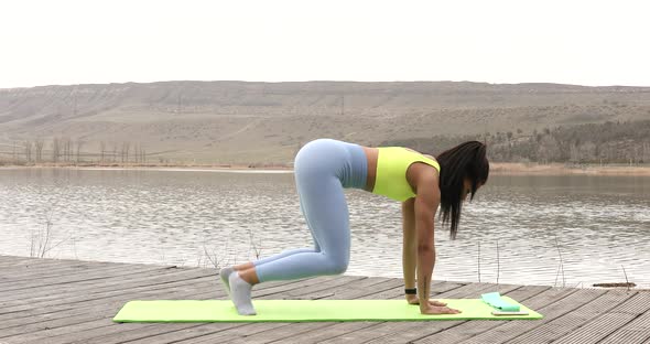 Active fitness young woman working out abdominals.