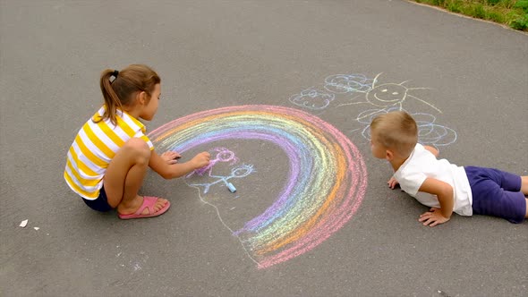 Children Draw with Chalk on the Asphalt