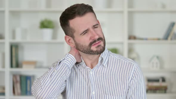 Portrait of Tired Young Man Having Neck Pain