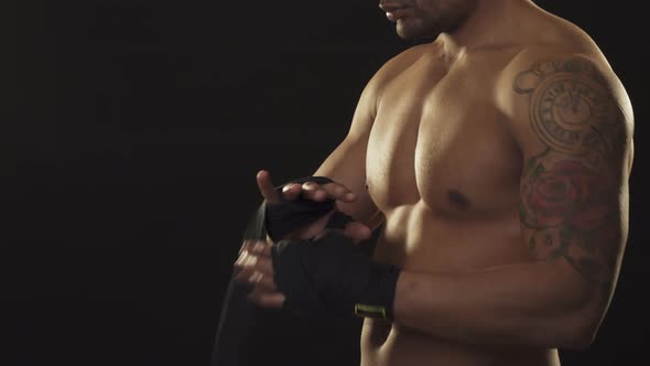 African Male Boxer Wrapping His Knuckles Before the Fight