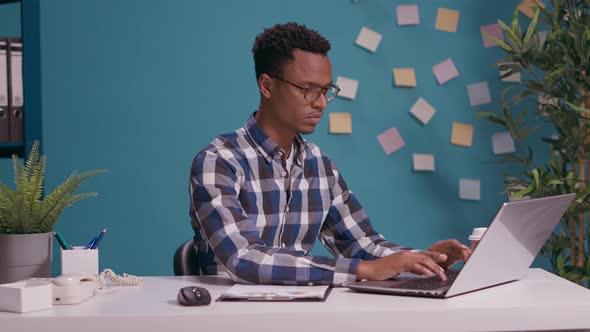 Disappointed Employee Sitting with Arms Crossed at Office Job