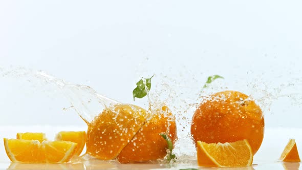 Fresh Oranges Dropped Into Water with Splash at 1000 Fps
