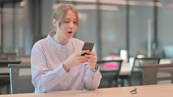 Upset Young Woman Reacting to Loss on Smartphone