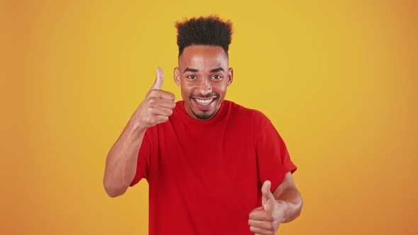 Happy Black Guy Gesturing Thumb Up and Widely Smiling