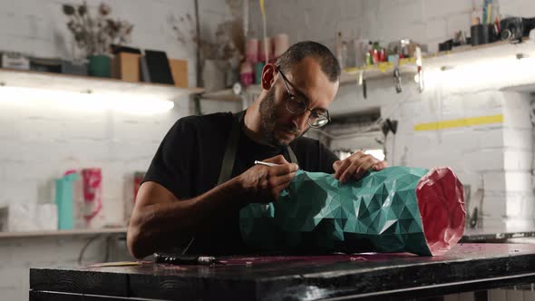 Close-up: male artisan, sculptor works, in the workshop