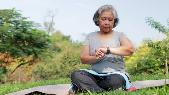 Asian elderly woman exercising in the park in the morning