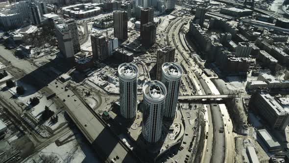 Three Tall Modern Buildings Standing in the Middle of a Dirty City