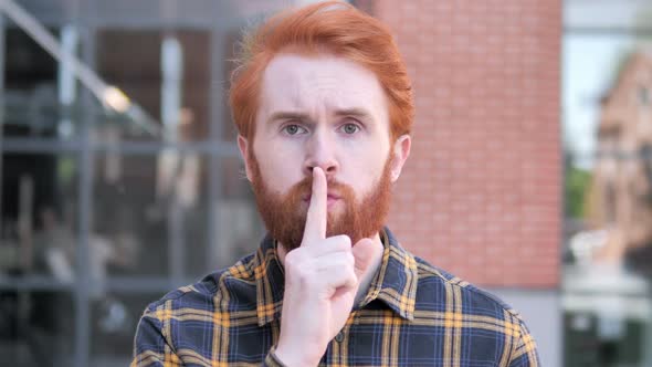 Silence Please Finger on Lips By Redhead Beard Young Man