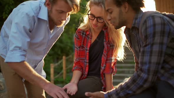 Caucasian Male with Beard Standing Near Blonde Female Discussing with African American Man Something