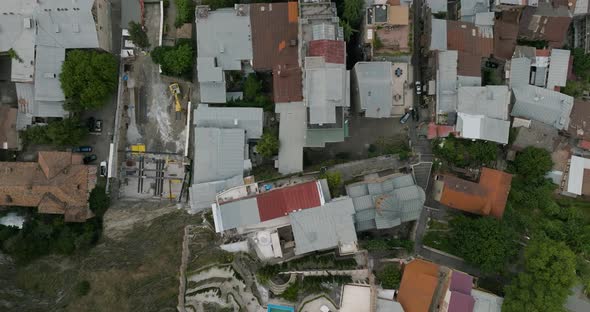 Pan left aerial down shot of a gloomy neighborhood in Tbilisi, Georgia.