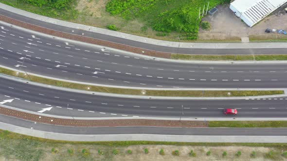 Aerial top down view of interchange road junction traffic. Drone shot flying