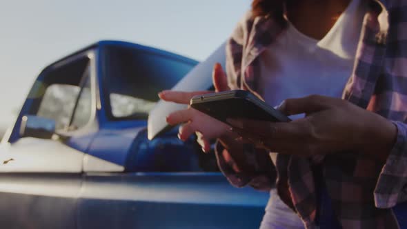 Young woman on a road trip in pick-up truck