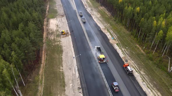 Maintenance, repair of roads. Laying of new asphalt pavement by heavy equipment