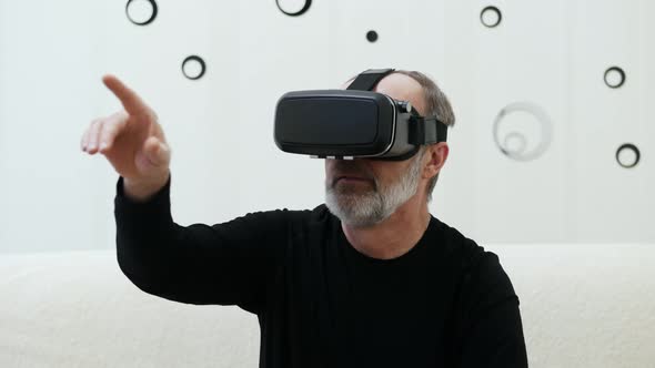 Adult Man Using Virtual Reality Glasses at Home Journey in the Metaverse