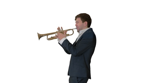 Man in suit standing playing trumpet on white background.