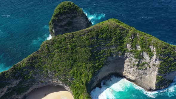  Kelingking beach, Nusa Penida, Bali, Indonesia. Aerial view at sea and rocks.