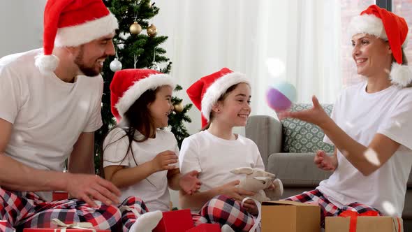 Happy Family Opening Christmas Gifts at Home