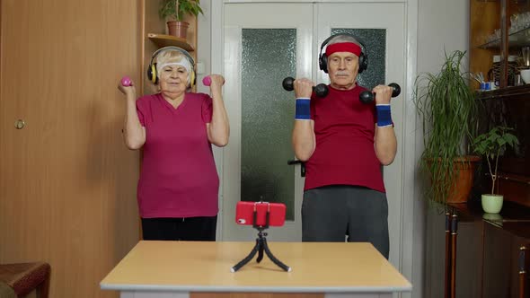 Senior Elderly Couple Grandmother Grandfather Doing Workout with Dumbbells Fitness Exercising