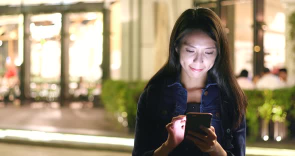 Businesswoman use of cellphone in Hong Kong city 