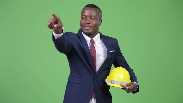 Young Happy African Businessman As Engineer Directing