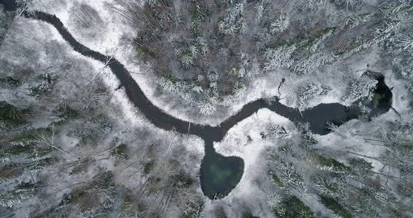 Heart Shape Sacred Spring Lake in Snowy Winter Forest Aerial Top View