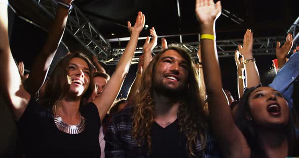 Group of people dancing at a concert 4k