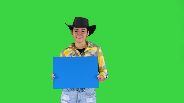 Smiling Pretty Cowgirl Holding Empty Board and Dancing on a Green Screen, Chroma Key