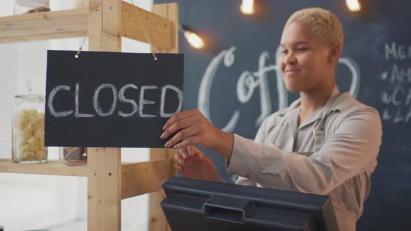 Coffee Seller Turning Open Sign At Store