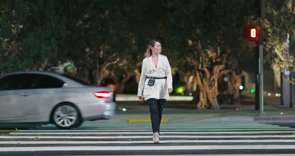 Confident Stylish Blonde Model Walks Catwalk on Night Urban Street Background