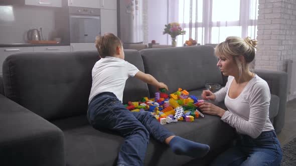 Mother and Son Playing Toy Constructor at Home