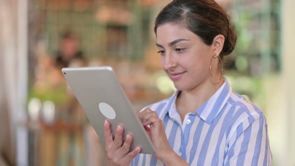 Excited Latin Woman Celebrating Success on Smartphone