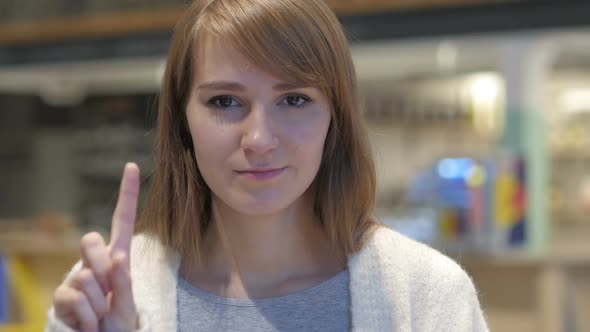 Portrait of Young Woman Waving Finger to Refuse No