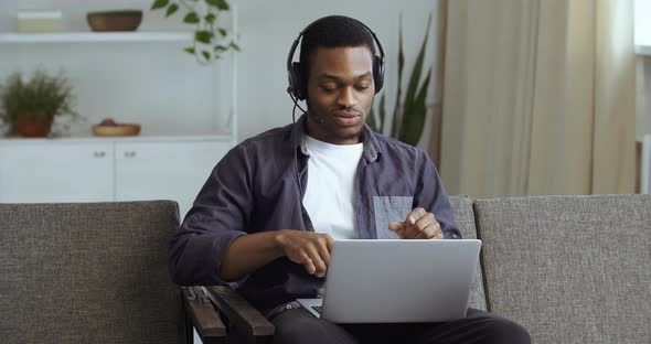 Black Guy Afro American Businessman Freelancer Student Teenager in Headphones with Laptop Listening