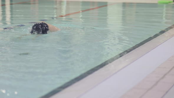 Little Baby Kid Child Training to Swim in Swimming Pool Boy Learning Work Out