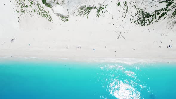 Drone view of scenic beach with white sand and turquoise sea, Greek islands.