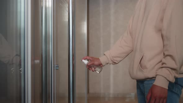 Closeup of Man's Hands Using a Sanitizer and a Wet Towel for Desinfection of Doors Knob