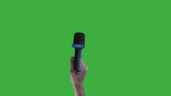 Hand holding Microphone For Live Press Conference interview with green screen