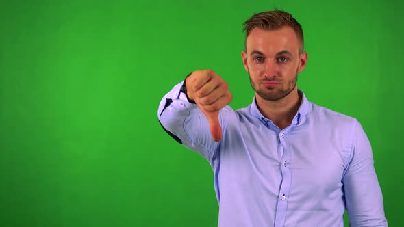 Young Handsome Business Man Disagrees (Show Thumb Down) - Green Screen - Studio