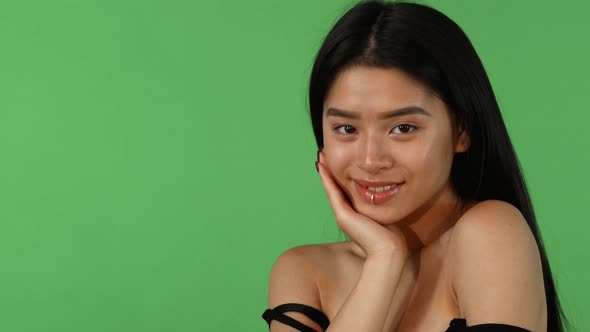 Asian Young Woman Posing Dreamily on Green Chromakey