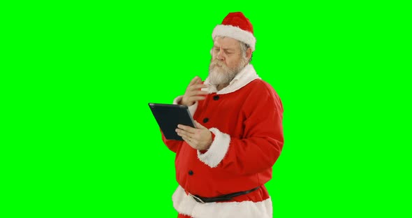 Santa claus using digital tablet 4k