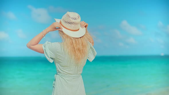 Woman Relaxing On Bahamas Flowing Dress Blowing In Wind.Travel Mood Wind Blows Dress On Ocean Resort