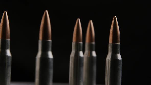 Cinematic rotating shot of bullets on a metallic surface - BULLETS