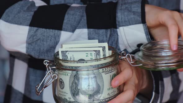 Dollar Banknote Saving Money in Glass Jar