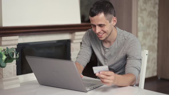 Man Using Laptop for Shopping Online with Credit Card