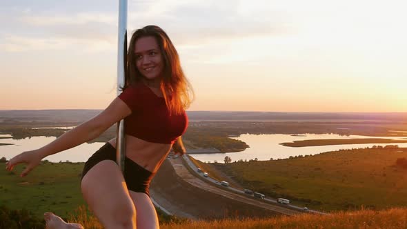 Pole Dance on Sunset - Young Woman Spinning By the Pole