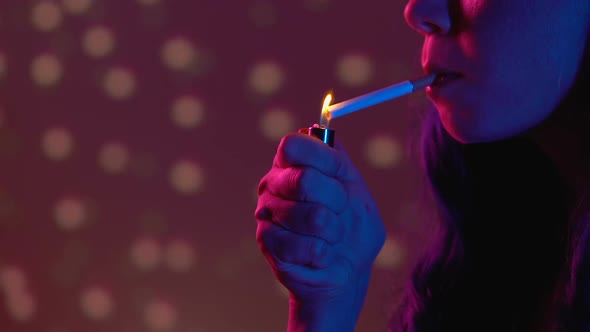 Young Lady Lighting Up Cigarette at Party in Night Club, Nicotine Addiction