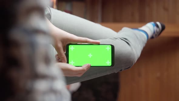 Young Woman at Home Lyung and Use Smartphone with Green Screen