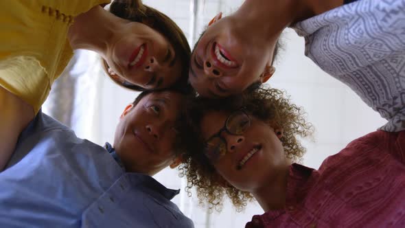 Happy multi-ethnic business colleagues forming huddles in modern office 4k